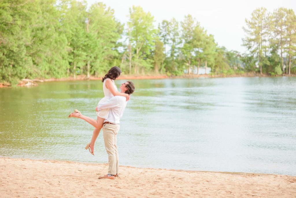 Jetton Park engagement photos with a beautiful lakeside beach behind the couple.